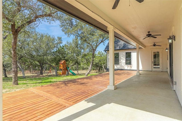 view of patio featuring ceiling fan, a deck, and a playground