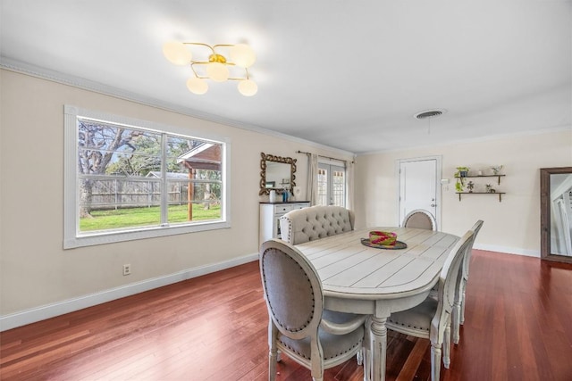 4608 Arapahoe Trl, Austin, TX 78745 - dining area with ornamental molding, dark wood-type flooring, and a chandelier