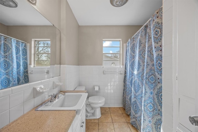 4608 Arapahoe Trl, Austin, TX 78745 - full bathroom featuring vanity, tile patterned floors, plenty of natural light, tile walls, and wainscoting