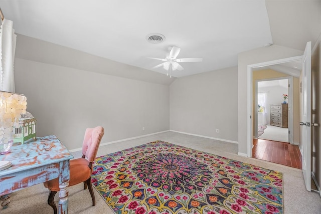 carpeted home office featuring lofted ceiling, a ceiling fan, and baseboards