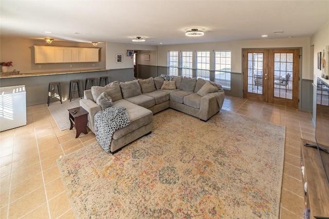living area with recessed lighting, french doors, a wainscoted wall, and light tile patterned floors