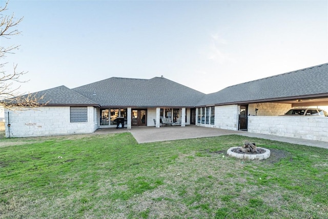 back of house with roof with shingles, a patio, fence, and a lawn