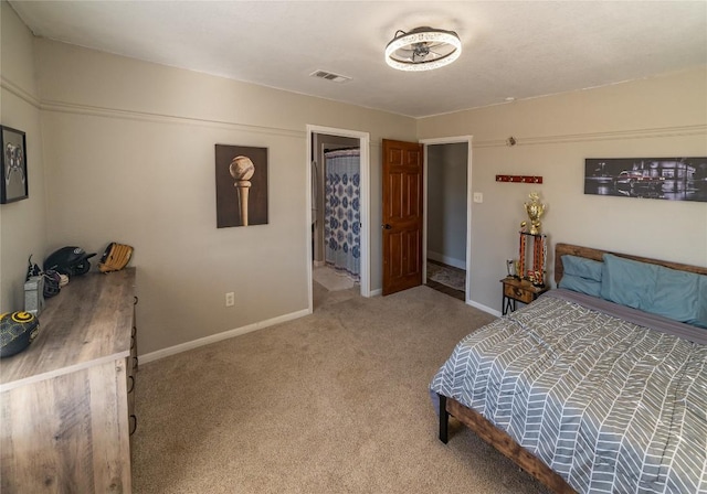 bedroom featuring baseboards, visible vents, and light colored carpet