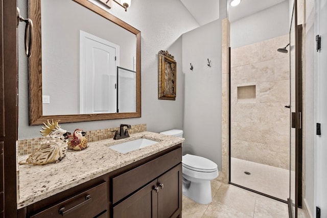 full bathroom featuring toilet, a shower stall, and vanity