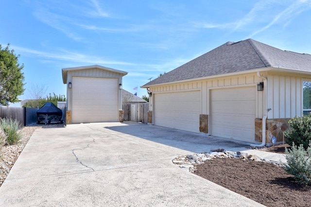 detached garage featuring fence