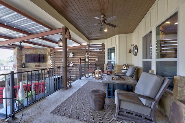 view of patio / terrace with a balcony, an outdoor fire pit, and a ceiling fan