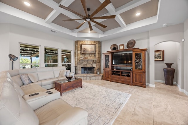 living room with baseboards, visible vents, coffered ceiling, arched walkways, and a fireplace