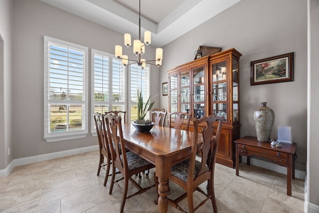 dining room featuring a chandelier, light tile patterned flooring, and baseboards