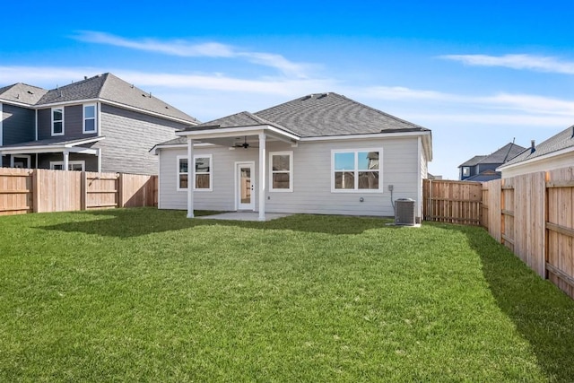 rear view of property featuring a yard, central air condition unit, a patio area, ceiling fan, and a fenced backyard