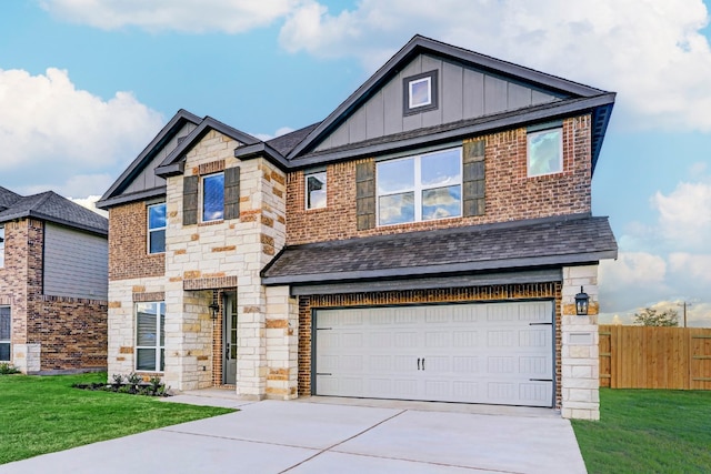 view of front of property featuring board and batten siding, fence, stone siding, driveway, and a front lawn