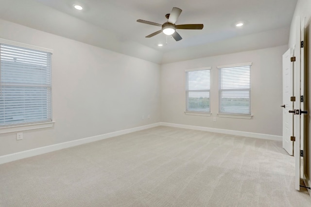 spare room with recessed lighting, light colored carpet, ceiling fan, and baseboards