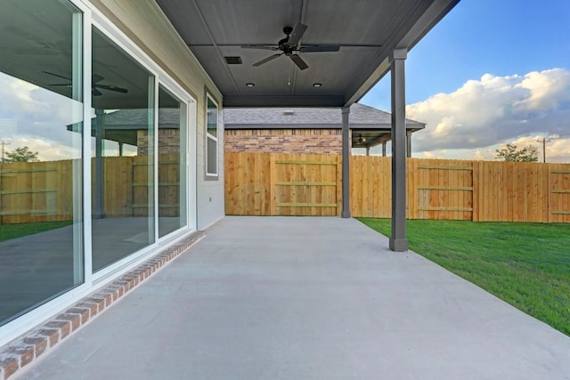 view of patio / terrace with ceiling fan and fence