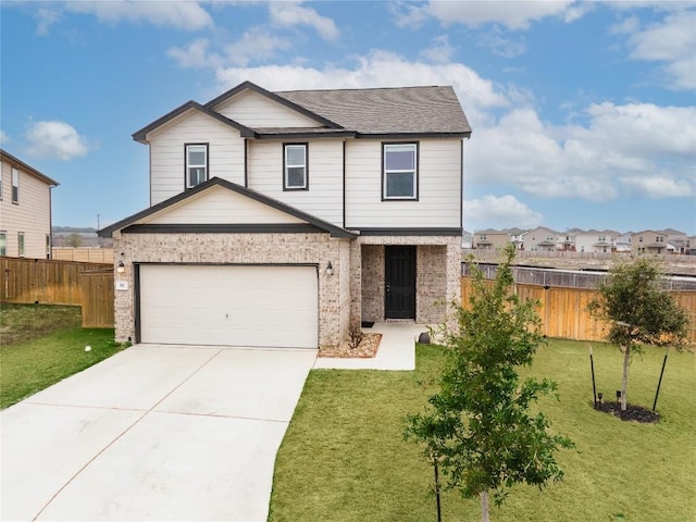 view of front of home with driveway, a front yard, fence, and brick siding