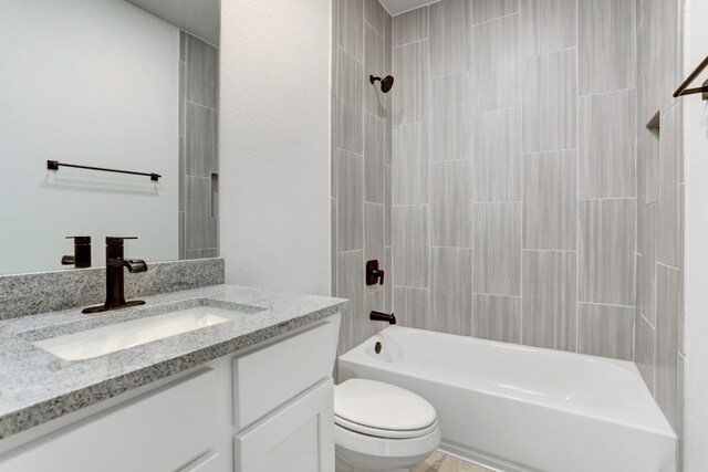 bathroom featuring  shower combination, toilet, and vanity