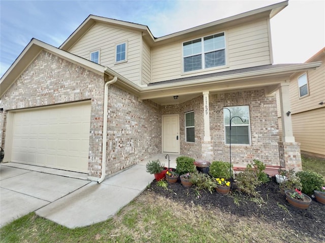 view of front facade with concrete driveway, brick siding, a porch, and an attached garage