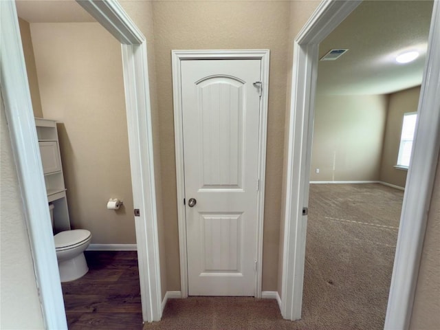 bathroom featuring visible vents, toilet, and baseboards