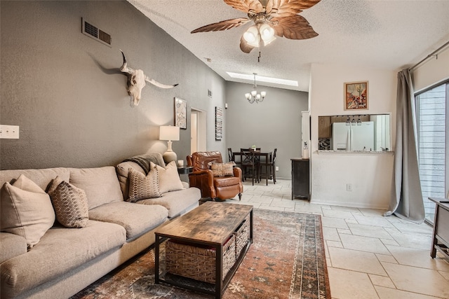 living area featuring a textured ceiling, ceiling fan with notable chandelier, lofted ceiling, and visible vents