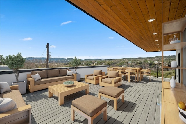 wooden deck featuring outdoor lounge area and a mountain view