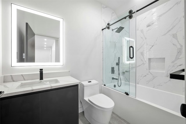 full bathroom featuring toilet, shower / bath combination with glass door, and vanity