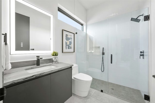 bathroom featuring toilet, a shower stall, tile patterned flooring, and vanity