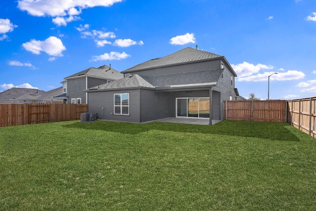 rear view of house with central AC, a patio area, a yard, and a fenced backyard