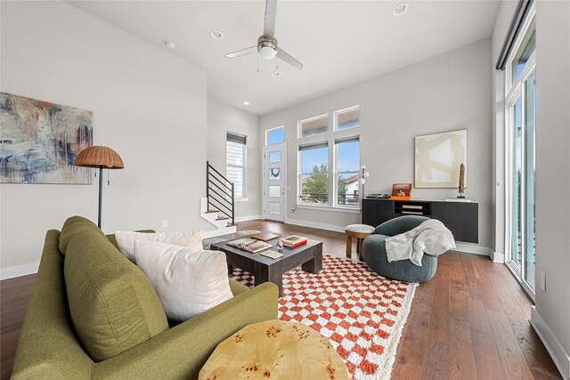 6221 Seville Dr, Austin, TX 78724 - living area featuring ceiling fan, stairway, baseboards, and hardwood / wood-style floors