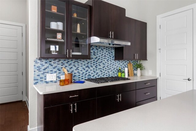 6221 Seville Dr, Austin, TX 78724 - kitchen featuring light countertops, dark brown cabinetry, under cabinet range hood, and stainless steel gas cooktop