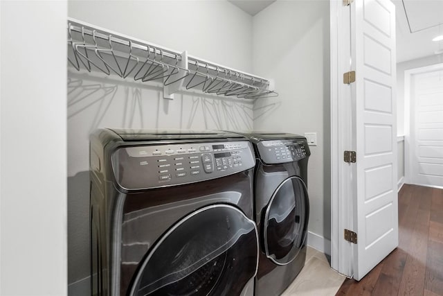 6221 Seville Dr, Austin, TX 78724 - laundry area featuring baseboards, washer and clothes dryer, attic access, laundry area, and wood finished floors