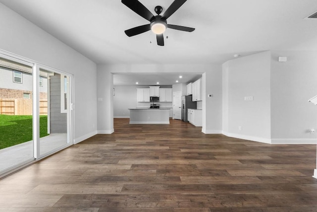 unfurnished living room with dark wood-style floors, recessed lighting, visible vents, ceiling fan, and baseboards