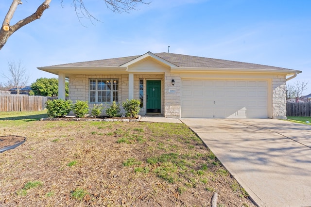 ranch-style house with driveway, a garage, fence, and a front yard