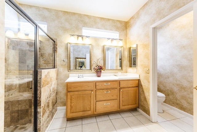 full bath with double vanity, toilet, tile patterned flooring, a shower stall, and a sink