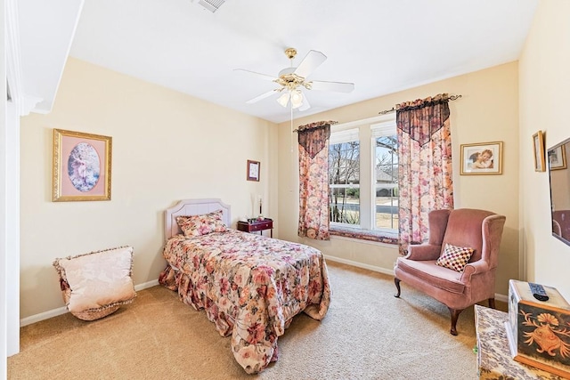 carpeted bedroom with ceiling fan and baseboards