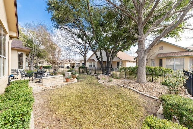 view of yard with a residential view, a patio area, and a fenced backyard