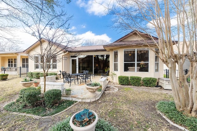 back of property featuring a patio, fence, and stucco siding