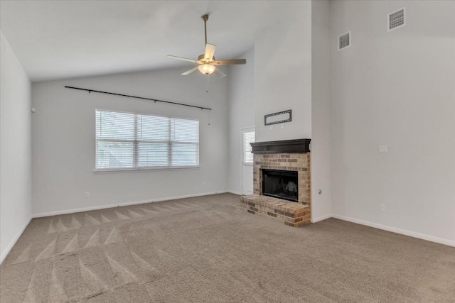 unfurnished living room with light carpet, a fireplace, a ceiling fan, visible vents, and baseboards