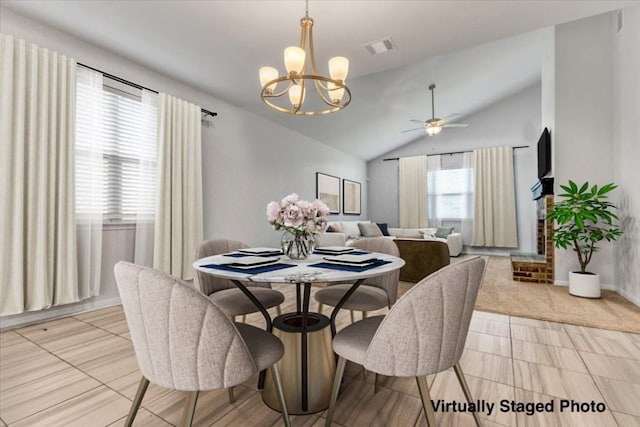 dining room with visible vents, vaulted ceiling, and ceiling fan with notable chandelier