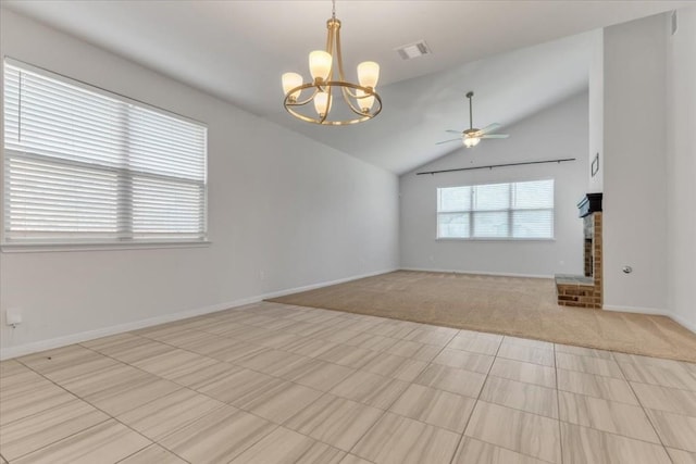 unfurnished room with a fireplace, light colored carpet, visible vents, vaulted ceiling, and ceiling fan with notable chandelier