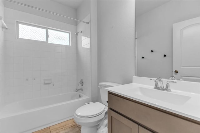 bathroom featuring wood finished floors, vanity, toilet, and shower / bathtub combination