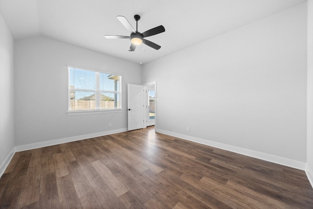 spare room featuring lofted ceiling, ceiling fan, baseboards, and dark wood-style flooring