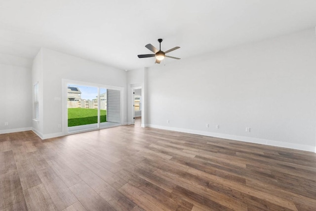 unfurnished living room with a ceiling fan, baseboards, and wood finished floors