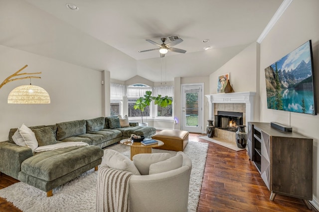 living area featuring lofted ceiling, a tile fireplace, recessed lighting, a ceiling fan, and dark wood-style floors