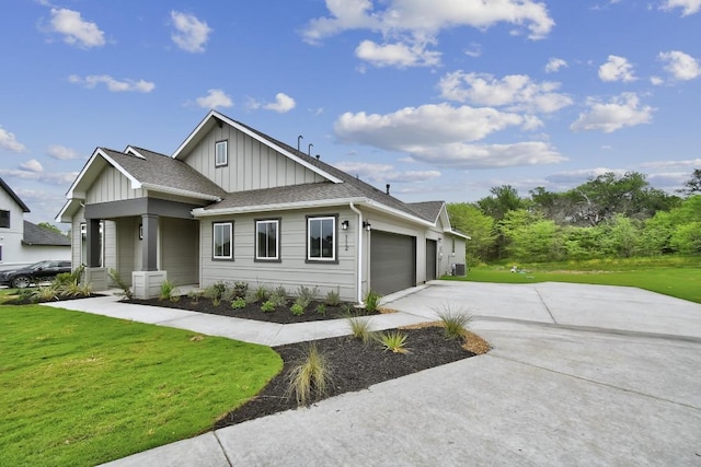 view of front of house featuring a garage, board and batten siding, driveway, and a front yard