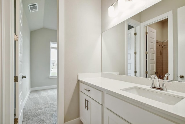 full bath featuring visible vents, a shower, vanity, baseboards, and lofted ceiling