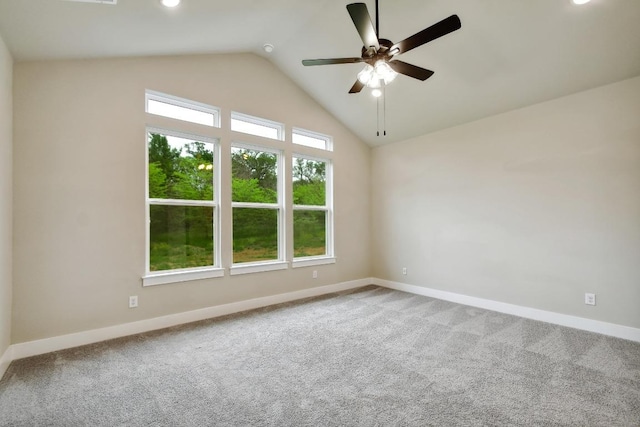 unfurnished room with carpet flooring, a ceiling fan, baseboards, and lofted ceiling