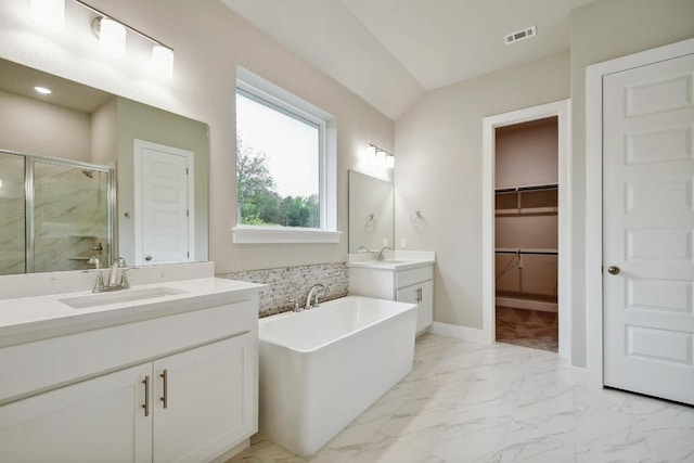 bathroom featuring visible vents, a freestanding tub, a shower stall, a sink, and marble finish floor