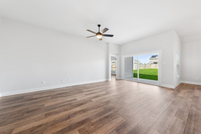 spare room featuring a ceiling fan, baseboards, and wood finished floors