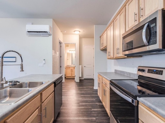 kitchen featuring light brown cabinets, dark wood-type flooring, a sink, an AC wall unit, and appliances with stainless steel finishes