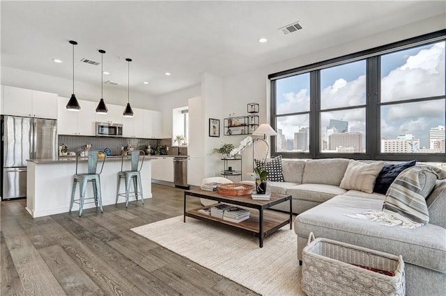 800 Embassy Dr Unit 319, Austin, TX 78702 - living area with healthy amount of natural light, recessed lighting, wood finished floors, and a city view