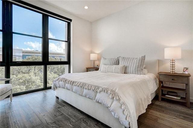 800 Embassy Dr Unit 319, Austin, TX 78702 - bedroom with multiple windows, wood finished floors, and recessed lighting