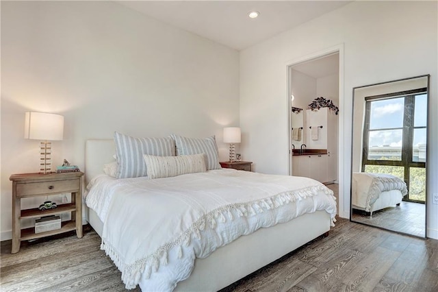 bedroom featuring recessed lighting and wood finished floors